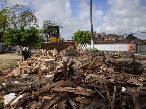 Trator recolhe destroços da demolição na praça central do Colina