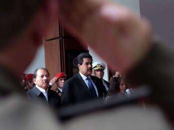 O presidente em exercício da Venezuela, Nicolás Maduro (à direita), presta homenagem a Hugo Chávez durante funeral na Academia Militar de Caracas