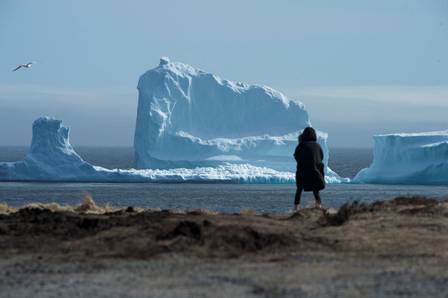 66432770_a-resident-views-the-first-iceberg-of-the-season-as-it-passes-the-south-shore-also-known-as